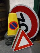 Four traffic cones and four traffic signs