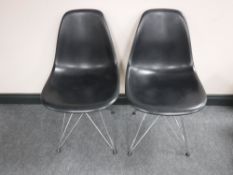 A pair of Vitra Eames black plastic dining chairs on chrome legs CONDITION REPORT: