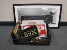 A crate containing contemporary canvases, frames, home theatre signs,