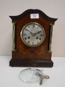 An Edwardian inlaid mahogany mantel clock with silvered dial and French movement