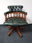 A green button leather captain's desk chair