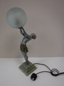An Art Deco style figural table lamp with glass ball shade on marble base