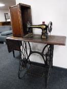 A Singer treadle sewing machine in table