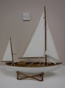 A wooden pond yacht on stand,