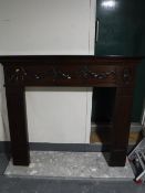 A wooden fire surround and marble hearth