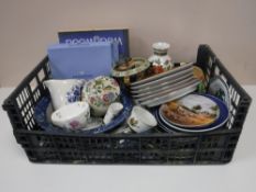 A box containing an iron stone blue and white bowl, Princess Diana collectors plates,