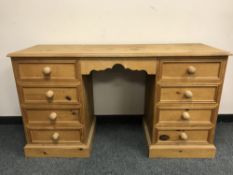 A pine kneehole dressing table,