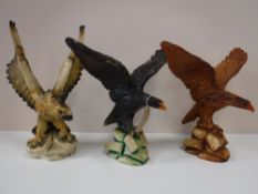 Three resin figures of eagles
