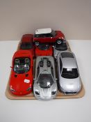 A tray containing six large scale die cast vehicles, Burago, Maisto, including sports cars,