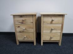 A pair of pine three drawer bedside chests,