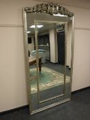 An ornate silvered mirror,