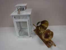 A copper wall lantern and a hurricane lamp