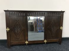 An early 20th century oak mirrored coat rack