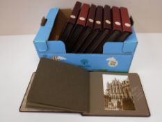 A box containing eight 1950's photo albums,