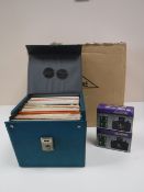 A box of sports 35 mm cameras and a case of 7 inch singles - easy listening