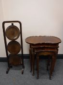 A nest of three mahogany shaped tables and a folding cake stand