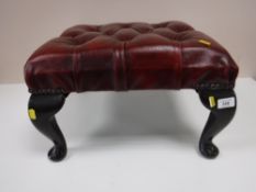 A red button leather chesterfield foot stool