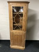A pine glazed door corner cabinet