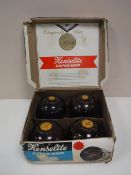 A set of four cased Henselite medium weight lawn bowls