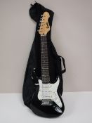 A childs electric guitar in carry bag