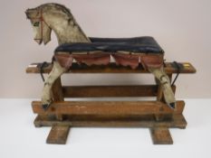An antique hand painted miniature rocking horse on stand
