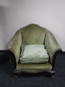 A Victorian mahogany framed scroll arm armchair upholstered in a green dralon