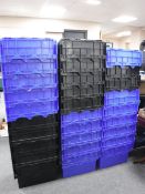 Approximately twenty nine plastic storage crates with lids