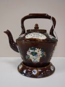 An early 20th century bargeware teapot on stand