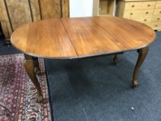 A Victorian mahogany wind out table with leaf on claw and ball feet