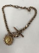A full gold sovereign - 1912, suspended upon a 9ct gold watch chain, 33.5g gross.