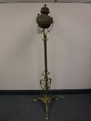 An antique brass rise and fall standard oil lamp