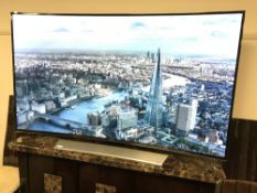 A Samsung 65 inch LCD UHD curved Smart TV, on stand, model number UE65HU8500T,
