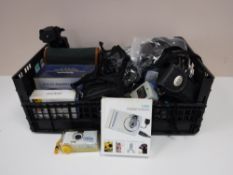 A box containing camera tripods, cased binoculars, digital cameras, camera cases, leads,