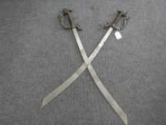 A pair of Eastern swords with brass dragon handles