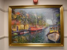 A gilt framed oil on canvas - boats on a canal,