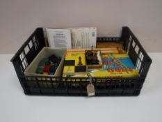 A box of vintage board games, die cast vehicles,