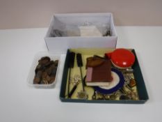 A box containing military badges, war money, coins, buttons,