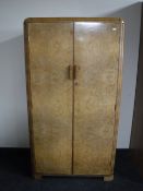 A figured walnut double door gent's wardrobe