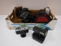 A box containing camera equipment, including a Sigma zoom lens,