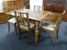 A 20th century oak pull out table and five chairs