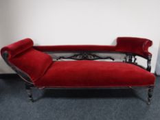 An antique mahogany chaise longue upholstered in a red dralon