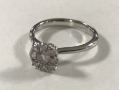 A diamond cluster ring, the total diamond weight estimated at 0.