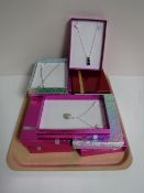 A tray containing eleven boxed costume necklaces