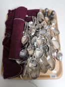 A tray containing a large quantity of plated cutlery,