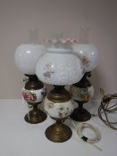 Three brass and china oil lamps with chimneys and shades (converted)
