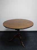 A Georgian and later oak tilt top pedestal table