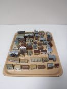 A tray containing approximately forty four miniature Wade houses and buildings