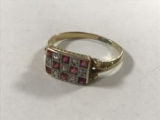An 18ct gold ruby and diamond ring, size O.