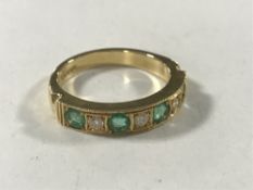 An 18ct gold emerald and diamond half-eternity ring,