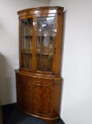 A yew wood double door corner display cabinet